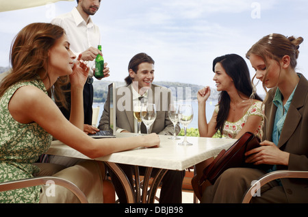 Office workers having drinks in outdoor cafe Stock Photo