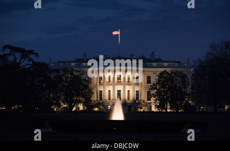 The White House, home of the President of the United States, seen from the South Lawn at dusk in Washington DC, USA. Stock Photo