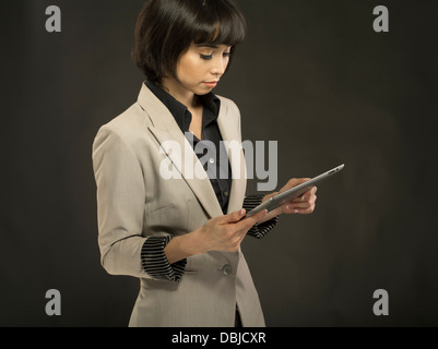 Young beautiful woman in her twenties using Apple iPad tablet computer Stock Photo