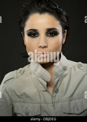 Young beautiful woman in her twenties wearing military style jacket Stock Photo
