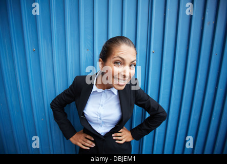 Image of happy businesswoman posing against blue Stock Photo