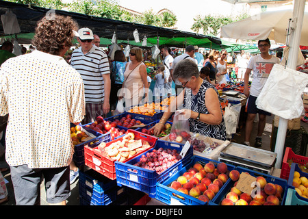 Fruit and vegetable stalls at the Pollensa old town Sunday market in the the main Plaza Mayor square Stock Photo