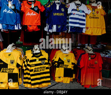 Pirate replica football shirts on sale in Carpenter Street, Kuching,the Malaysian owned clubs Cardiff & QPR plus national team Stock Photo
