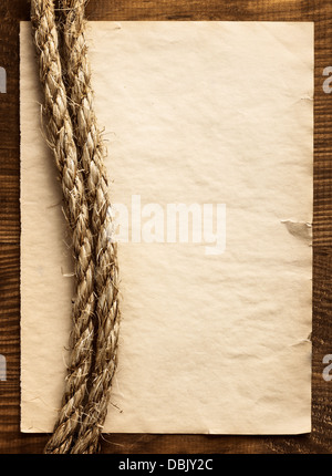 aged Rope on the old paper background Stock Photo