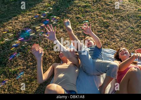 Persons In Garden Playing With Soap Bubbles, Croatia, Slavonia, Europe Stock Photo