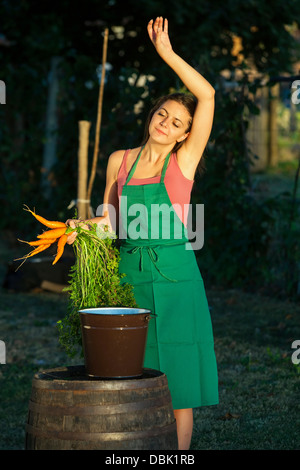 Woman In Garden Holding Carrots, Croatia, Slavonia, Europe Stock Photo