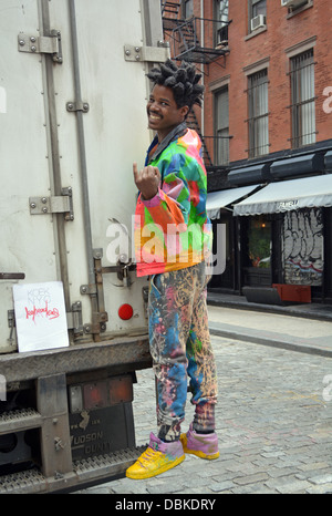 Portrait of Sidi known as Leghead, a New York artist, posing with one of his creations in the Soho section of downtown, NYC Stock Photo