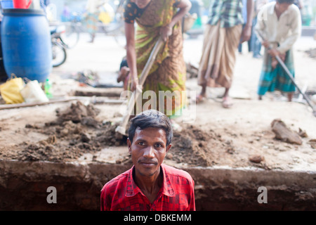 Rural Bangladeshi women perform manual labor carrying dirt for three dollars $3 a day on a road project in Chittagong Bangladesh Stock Photo