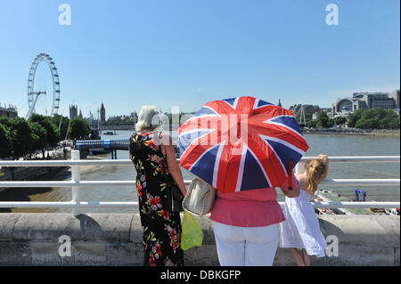 Waterloo Bridge, London, UK. 1st August 2013. A Union Jack umbrella acts as a parasol for this lady on Waterloo Bridge as the temperatures soar. Credit:  Matthew Chattle/Alamy Live News Stock Photo