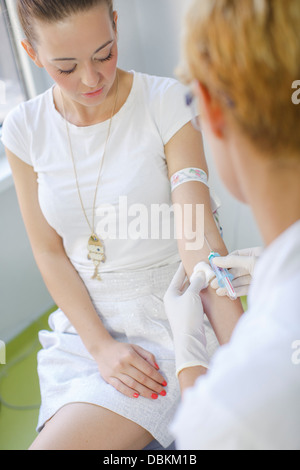 Female Doctor Takes Bood From A Patient Stock Photo
