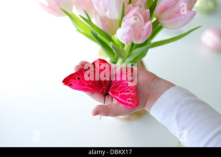 Person Holding Decoration Butterfly in Hands, Munich, Germany, Europe Stock Photo