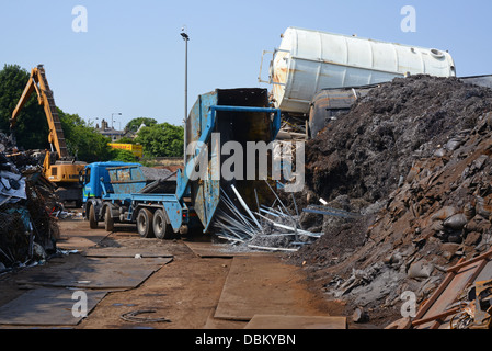 lorry emptying skip load of scrap metal for processing at scrapyard united kingdom Stock Photo