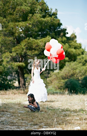 Bride And Little Girl, Bride Holding Bunch Of Balloons, Croatia, Europe Stock Photo