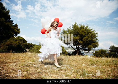 Bride With Bunch of Balloons On Meadow, Croatia Europe Stock Photo