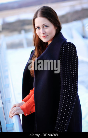Woman with brown hair wearing coat, looking at camera, Copenhagen, Denmark Stock Photo