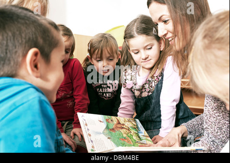 Teacher And Children In Nursery School, Kottgeisering, Bavaria, Germany, Europe Stock Photo