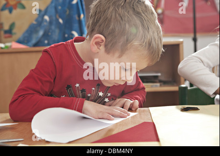 Children In Nursery School Folding Paper Planes, Kottgeisering, Bavaria, Germany, Europe Stock Photo