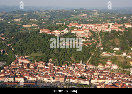 AERIAL VIEW. Medieval hilltop town overlooking the newest city at the foothill. Mondovi, Province of Cuneo, Piedmont, Italy. Stock Photo