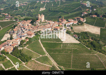 AERIAL VIEW. Medieval hilltop village surrounded by grapevines in the Langhe region. Serralunga d'Alba, Province of Cuneo, Piedmont, Italy. Stock Photo