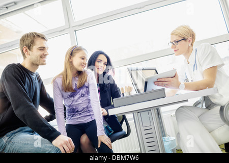 Female doctor explains diagnosis, using a digital tablet, Osijek, Croatia Stock Photo