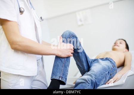 Female doctor examining leg of boy, Osijek, Croatia Stock Photo