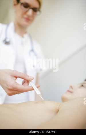 Female doctor taking temperature of boy, Osijek, Croatia Stock Photo