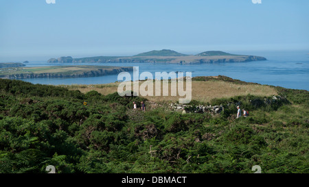 A view of Ramsey Island, Whitesands Bay and people walking on path at St. David's Head Pembrokeshire Wales UK  KATHY DEWITT Stock Photo