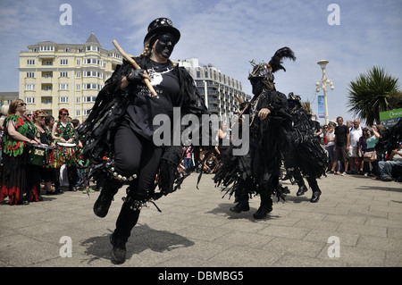 Hunters Moon morris dancers in costume and make up on the sea front during Eastbourne Lammas Festival 2013 Stock Photo