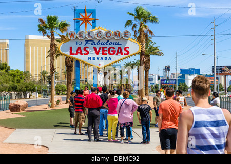 Tourists lining up to have a photo taken under the Welcome to Fabulous Las Vegas sign, Las Vegas, Nevada, USA Stock Photo