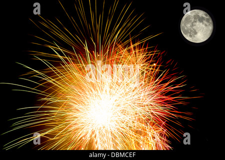 Amazing fireworks with the full moon in a dark night Stock Photo