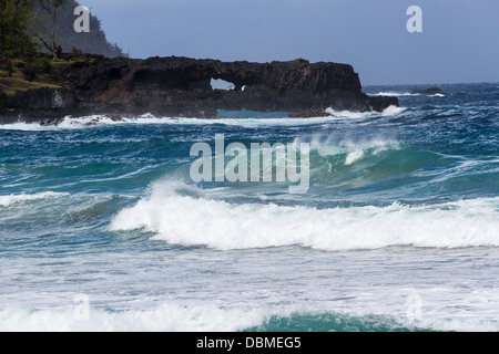 Arches and crashing waves at Kaihalulu Red Sand Beach on Maui in Hawaii. Stock Photo