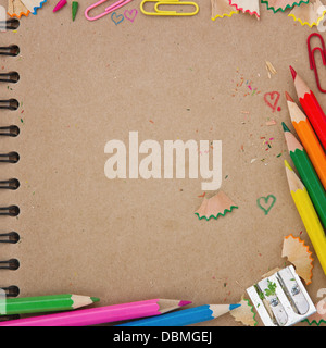 Back to school background with brown recycled paper notebook and colorful wooden pencils Stock Photo