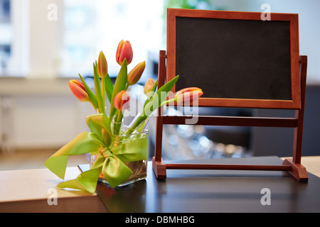 Empty small chalkboard standing on a hotel counter Stock Photo