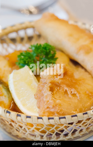 deep fried fish and chips in basket and slice lemon Stock Photo