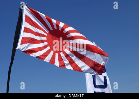 japanese flag waving on blue sky Stock Photo