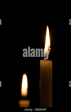 Two candles in the darkness. Stock Photo