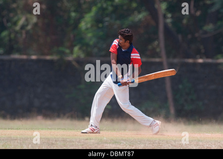 Cricket is a religion in India and you can see people playing cricket almost everywhere ! Here is a batsman playing his shots . Stock Photo