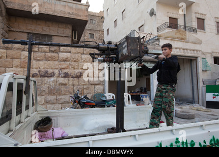 Aleppo, Syria: A Free Syrian Army boy takes aim with a dushka. Stock Photo