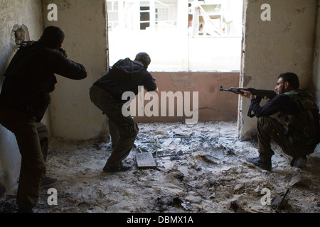 Aleppo, Syria: A Free Syrian Army member takes aim at a regime position in Karm AL Jabal. Stock Photo