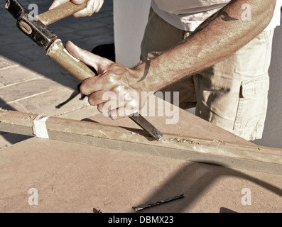 arms of a carpenter working with wood Stock Photo