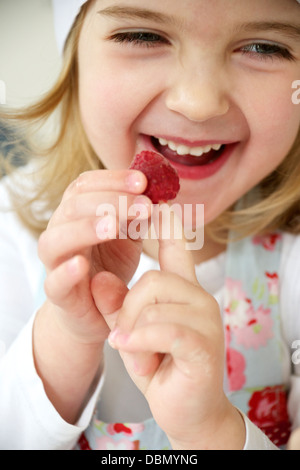 Little girl fooling around with raspberries, Munich, Bavaria, Germany Stock Photo