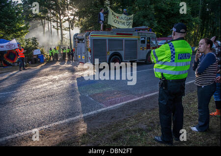 Balcombe, West Sussex, UK. 1st August 2013. The  gate is blocked early this morning by an old fire engine driven and then disabled by the Frack Fighters.  they are a group of environmental protestors and include Tamsin Omond. Anti fracking protestors continue their blockade of the Cuadrilla test drill near Balcombe, West Sussex, UK. 01 August 2013. Credit:  Guy Bell/Alamy Live News Stock Photo