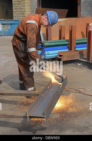 engineer using oxyacetylene torch to cut length of steel to size Stock Photo