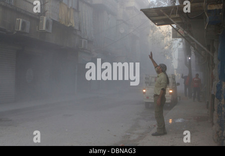 November 1, 2012 - Aleppo, Syria: People react to three mortars being fired into a building and road. Stock Photo