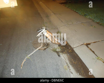 MAN STUCK HEADFIRST IN MANHOLE  A man, who was found by firemen with his legs sticking out of a manhole, claims four members of a gang forcibly wedged him in the sewer - having thrown his mobile cell phone down the drain. Twenty one year-old, Jared Medeiros was trapped for 40 minutes in the manhole on Block of Hale Aloha Way, Ceres, California (21 July). Sixteen-year-old Brianna Mo Stock Photo