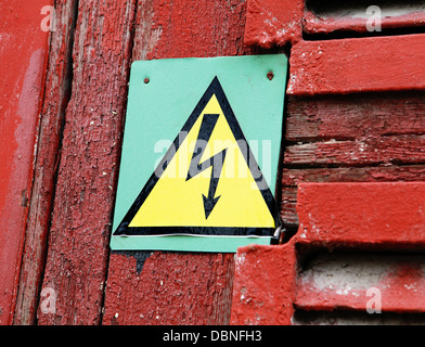 danger high voltage sign on red rusty door Stock Photo
