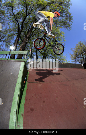 Teenager doing BMX bike stunt in skateboard park, Osijek, Croatia, Europe Stock Photo