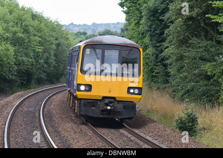 A diesel passenger train on the mainline approaching Deighton station near Huddersfield, West Yorkshire, England Stock Photo