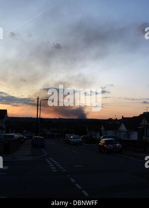 Smoke can still be seen rising from the large Sony factory that was set alight during the London riots on Monday evening. Shops and commercial businesses across London have closed early this afternoon, acting on advice from The Metropolitan Police, due to the last few days rioting and looting across the captial London - 09.08.11 Stock Photo