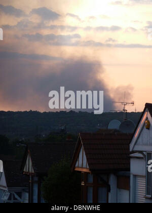 Smoke can still be seen rising from the large Sony factory that was set alight during the London riots on Monday evening. Shops and commercial businesses across London have closed early this afternoon, acting on advice from The Metropolitan Police, due to Stock Photo